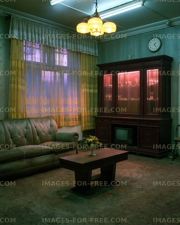 Old living room with vintage furniture and dim lighting