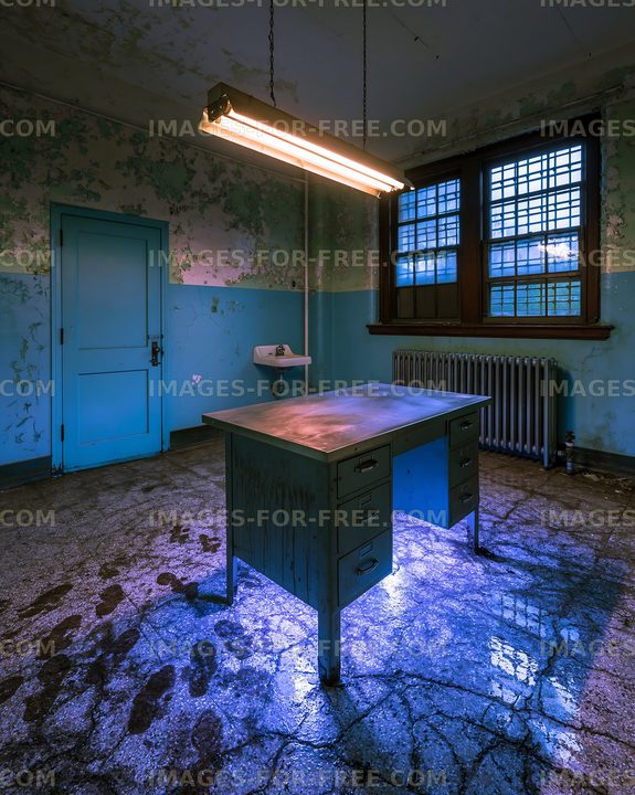 Abandoned room with a desk and overhead lighting