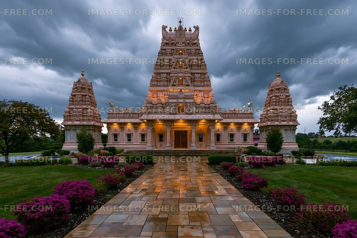 Temple stands under dark storm clouds near flower garden