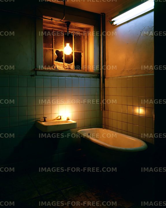 Atmospheric old bathroom with bathtub, tiles, and warm lighting