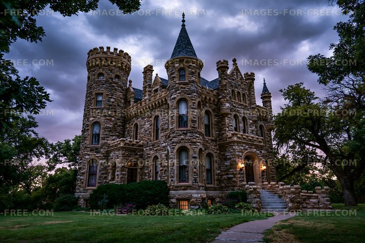 Stone castle-style house with turrets at dusk