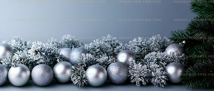 Frosted evergreen branches with silver holiday baubles
