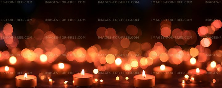 Warm glowing candles and orange bokeh lights