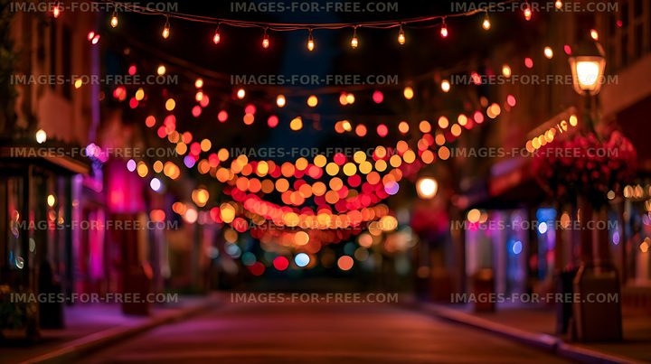 Colorful bokeh string lights on an illuminated urban street