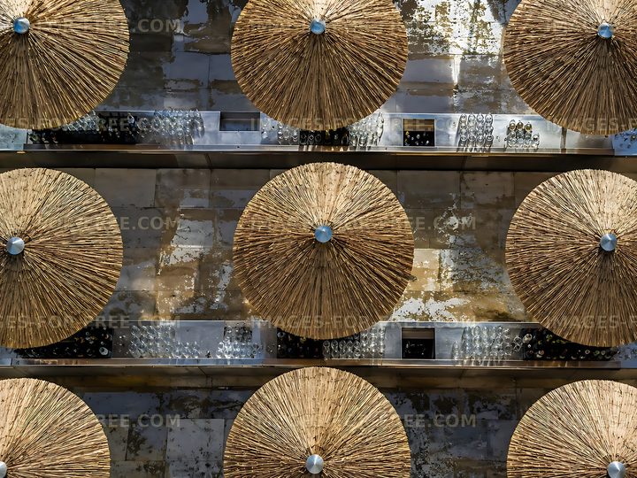 Roof of straw umbrellas arranged in a pattern